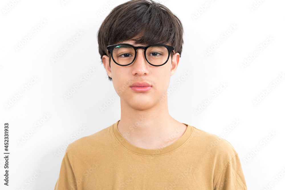 Handsome teen boy with glasses in casual brown t-shirt isolated on white background.