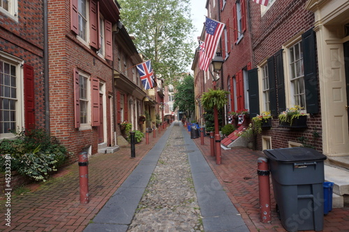 Historic Colonial Brick Row Hmes with Window Boxes Cobblestone Walkway on Summer Day