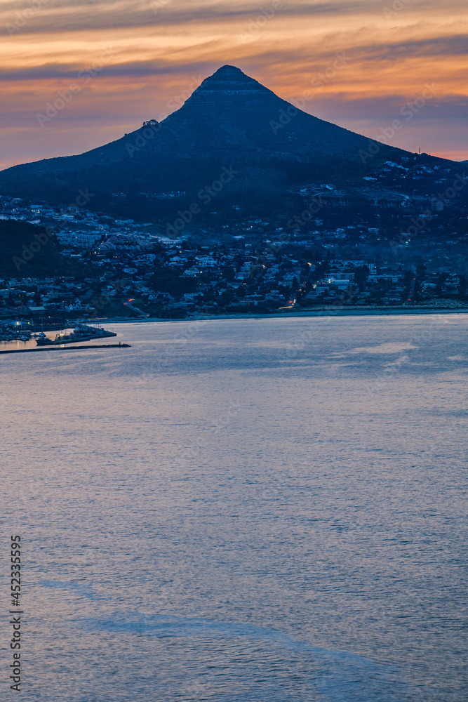 Portrait shot of Hout Bay with Lion's Head mountain in the backround at night from Chapman's Peak Cape Town