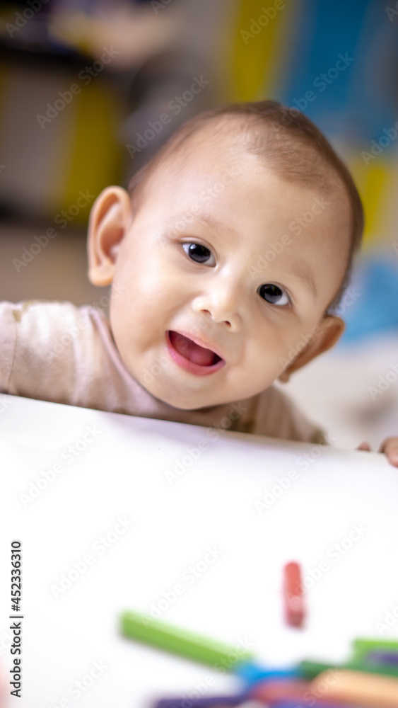 Baby Asian Girl drawing and playing as she develops her motor skills Baby Asian Girl drawing and playing as she develops her motor skills