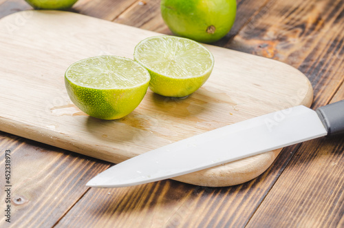 Sliced ​​limes with a white bladed knife.