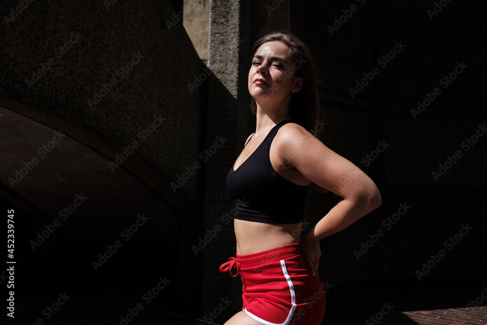 Young fitness woman posing in the city. Young fitness woman posing in the city.