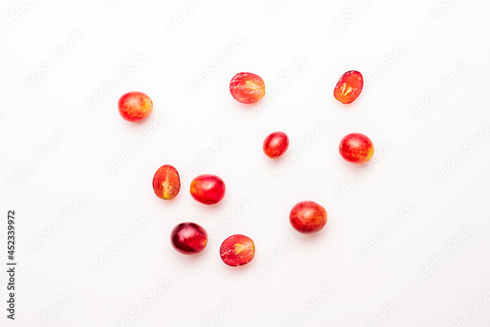 top view image of some claret red dessert grapes on white table top view image of some claret red dessert grapes on white table