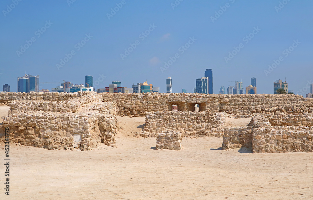 Ruins of the Bahrain Fort or Qal'at al-Bahrain with Manama Modern Cityscape in the Backdrop, Bahrain