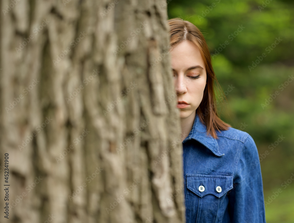 Portrait of beautiful young woman in forest.