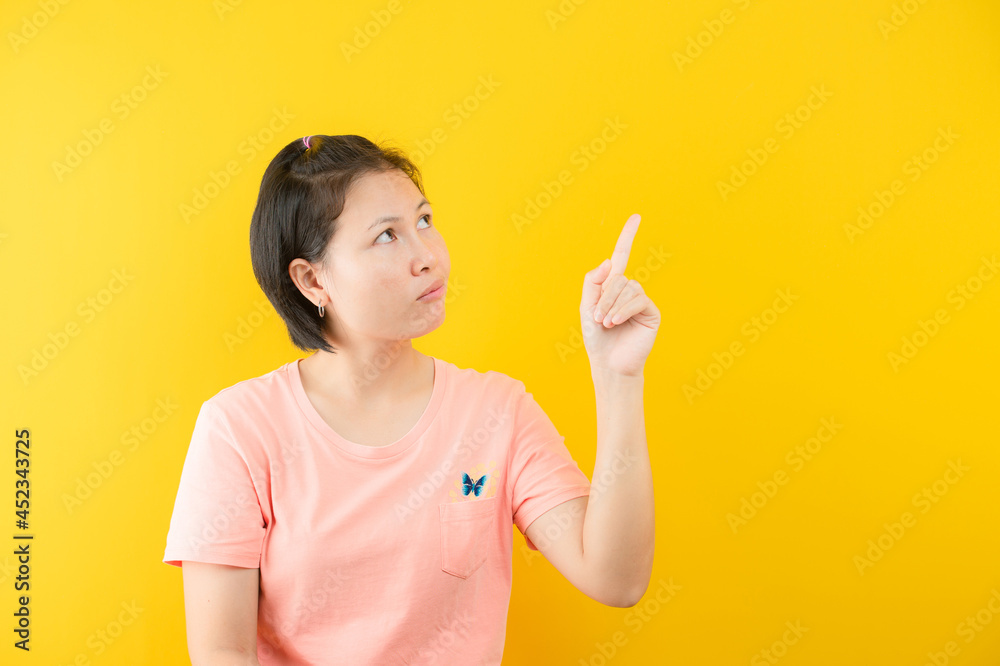 Closeup photo of amazing short hairdo lady looking up empty space deep thinking creative person arm on yellow color background Closeup photo of amazing short hairdo lady looking up empty space deep thinking creative person arm on yellow color background