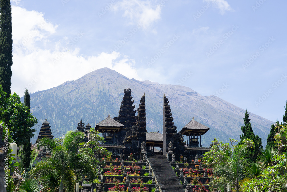 Photo of Besakih temple during the day of the pandemic which is quiet with tourists and a mountain background located in Bali, Indonesia.