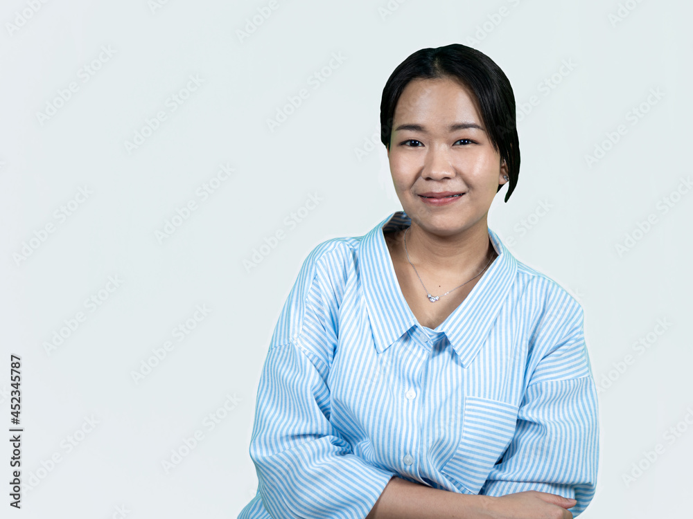 Young Asian woman in casual blue stripped shirt cross her arm confidence on white background Young Asian woman in casual blue stripped shirt cross her arm confidence on white background