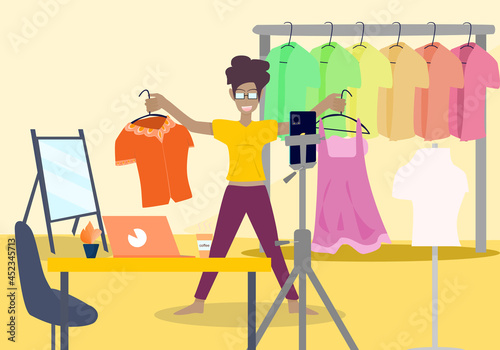 Concept people vlog livestream, lifestyle quarantine. Dark skinned woman wearing glasses going live selling fashion clothes at home, blogger, clothes, dress up and beauty. Vector flat illustration 