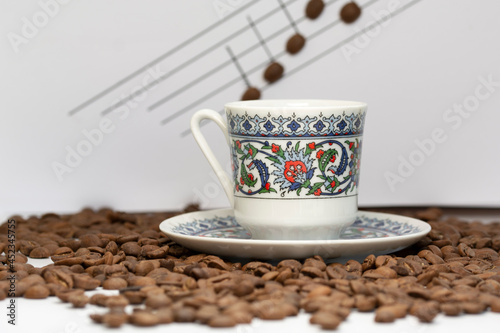 a cup of turkish coffee among the coffee grains