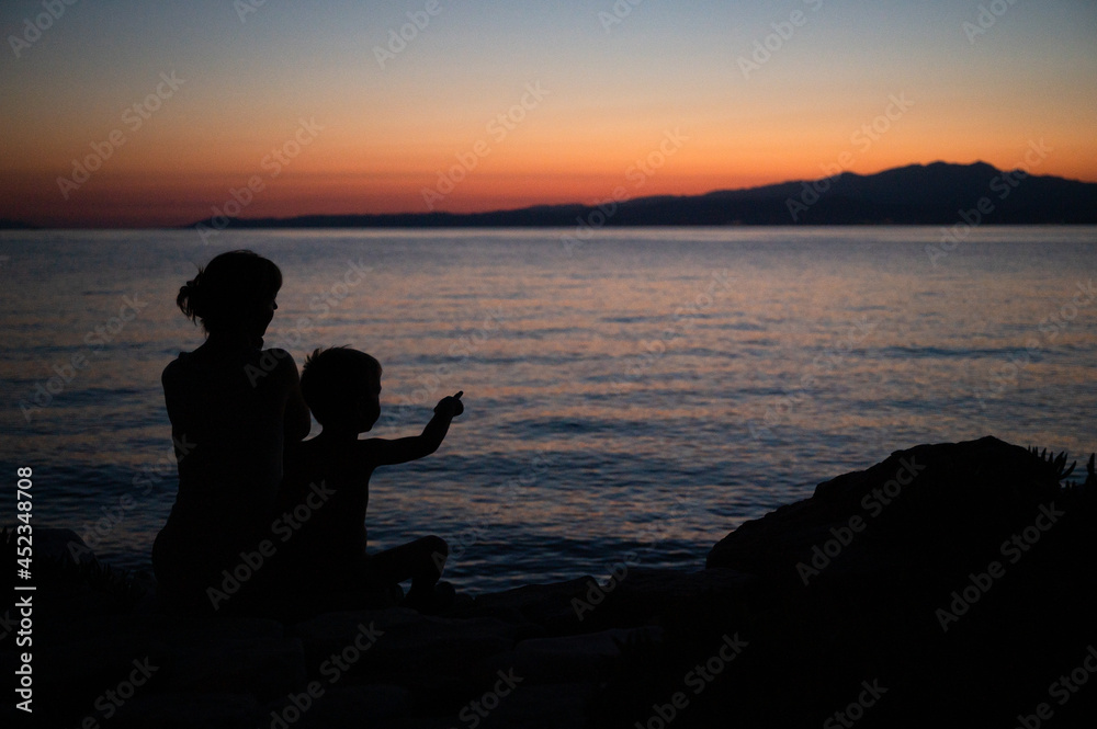 Summer sunset with silhouette family