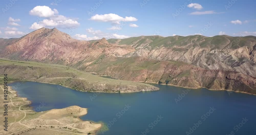 Reservoir in Armenia with turquoise water aerial view. Arid and desolate area with hills and mountains. Water from the pond is used for irrigation of farmland Reservoir in Armenia with turquoise water aerial view. Arid and desolate area with hills and mountains. Water from the pond is used for irrigation of farmland