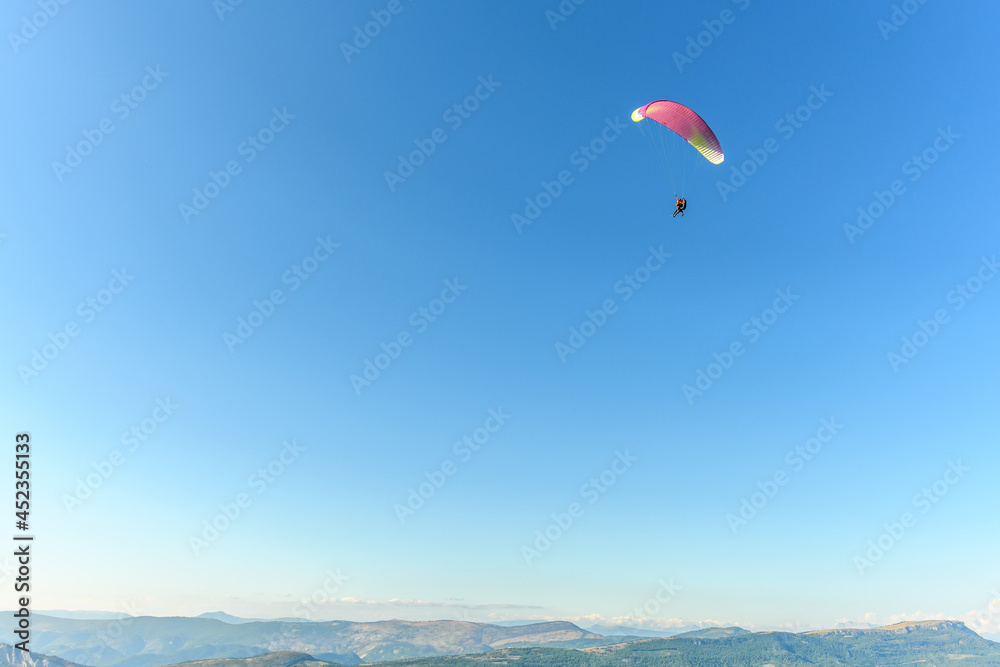 Paragliding flight in the air over the mountains. Paragliding flight in the air over the mountains.