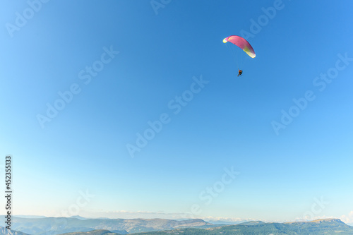 Paragliding flight in the air over the mountains.