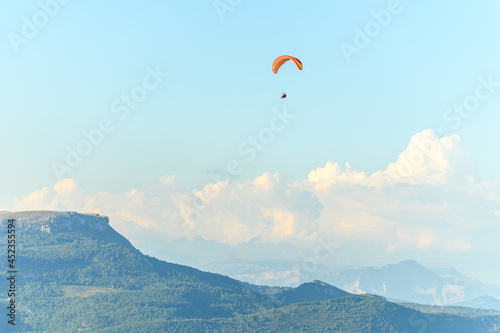 Paragliding flight in the air over the mountains.