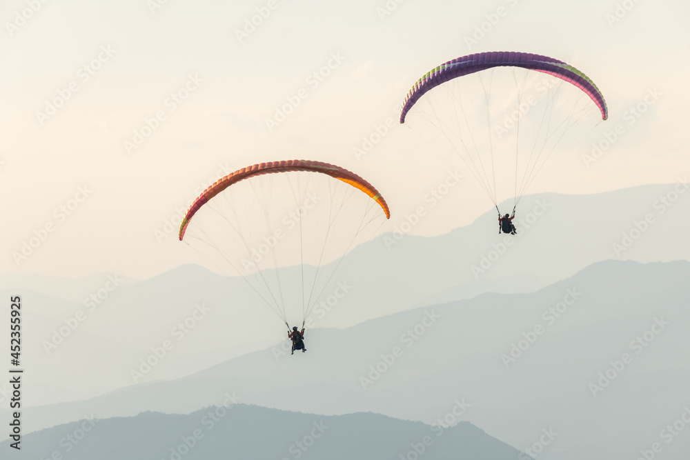 Paragliding flight in the air over the mountains. Paragliding flight in the air over the mountains.