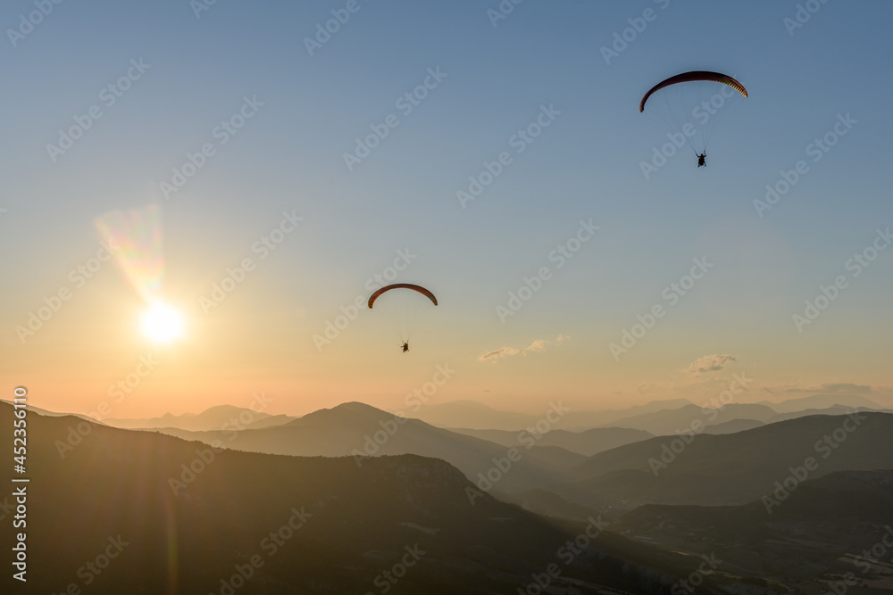 Paragliding flight in the air over the mountains. Paragliding flight in the air over the mountains.