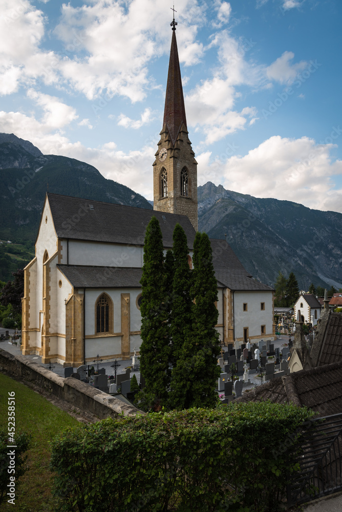 Catholic parish church of the Assumption of Mary ( Stadtpfarrkirche Maria Himmelfahrt) on a summer day with blue sky and clouds, Landeck, Austria, Europe