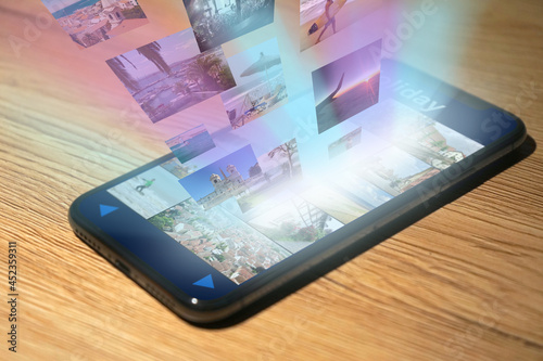 Obraz na plátne Photos and images are displayed on a modern smartphone and streamed as a hologr