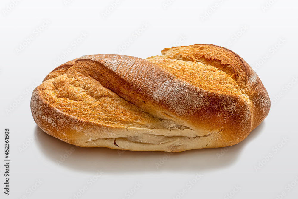 White homemade bread with a crispy crust on a light background