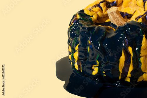 Closeup photography of old wrinkled pumpkin inthe liquid blue paint.Copy space for text. photo