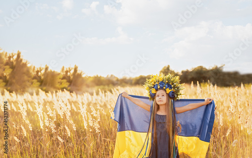 Ukraines Independence Flag Day. Constitution day. Ukrainian child girl with yellow and blue flag of Ukraine in field. flag symbols of Ukraine. Kyiv, Kiev day photo
