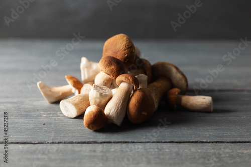 Porcini or white mushrooms from forest on wooden table. Rustic style.