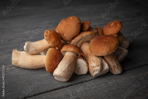 Porcini or white mushrooms on wooden table rustic style.