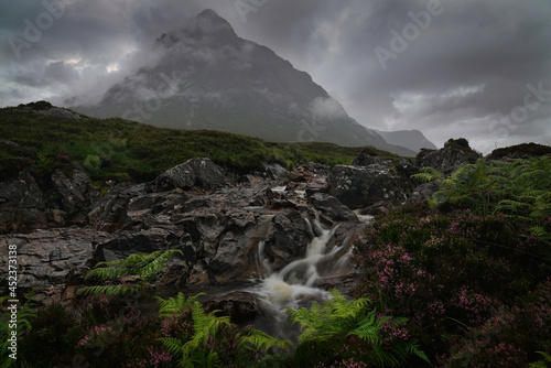 A moody image of the River Coupall with the Buachaille Etive Mor mountain in the Background. Located in Glencoe  Highlands  Scotland.