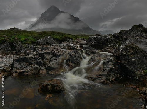 A moody image of the River Coupall with the Buachaille Etive Mor mountain in the Background. Located in Glencoe, Highlands, Scotland.