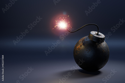 Foto A metal bomb in the form of a cannonball with a burning fuse
