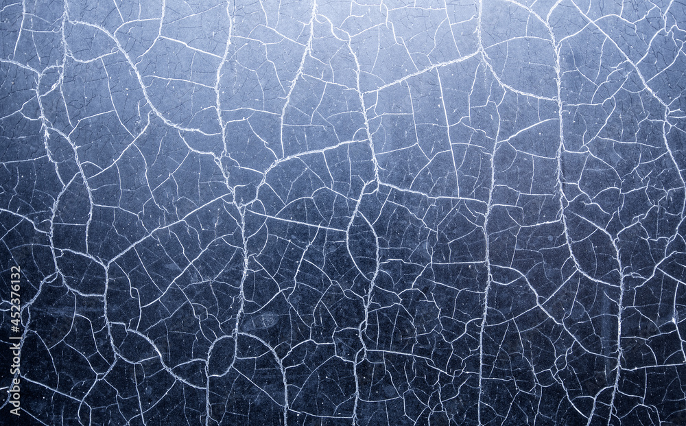 Many chaotic cracks on the surface of the textured material. Many chaotic cracks on the surface of the textured material.