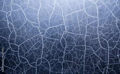 Many chaotic cracks on the surface of the textured material.