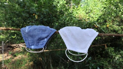 Close up of two cloth face mask hung on a rope