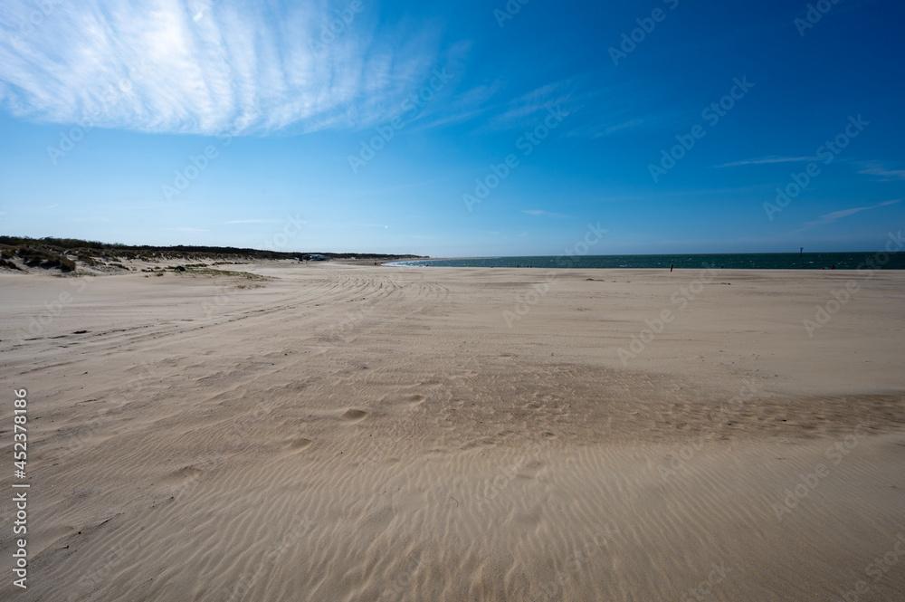 View on wide white sandy North sea beach in Renesse, Zeeland, Netherlands