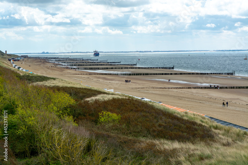 View on white sandy beach, dunes and water of North sea between Vlissingen en Domburg, Zeeland, Netherlands