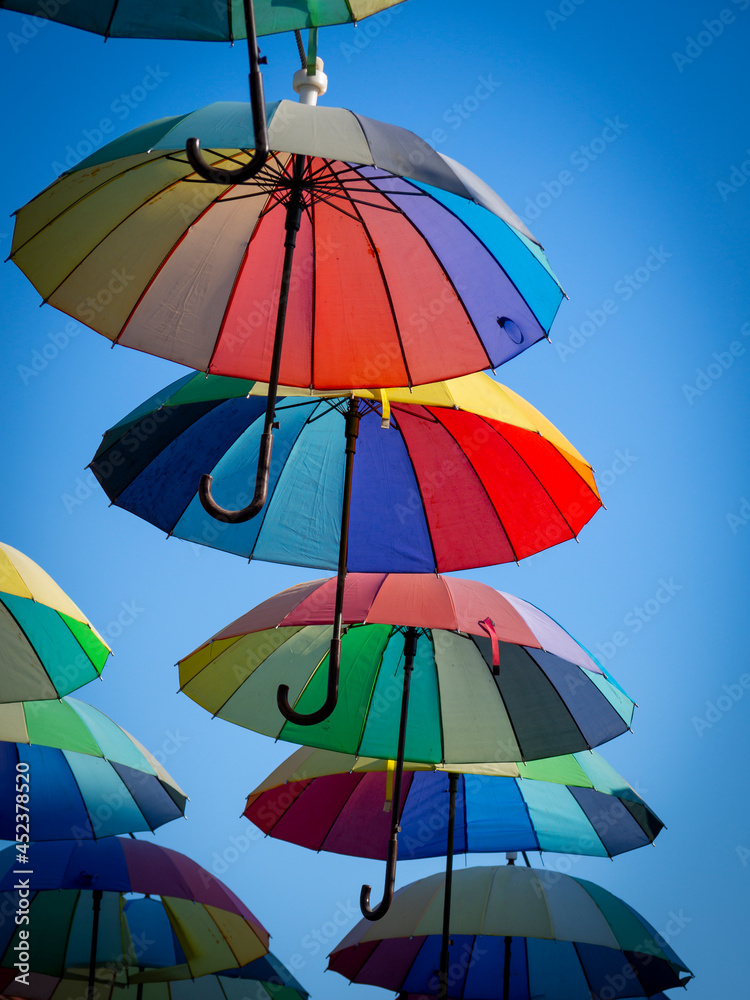 street decorated with colorful umbrellas in the blue sky
