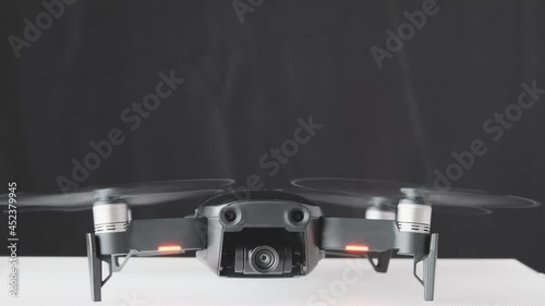 Drone quadcopter engine initiation front view, futuristic gadget and electronics, professional tool for video and photo 60 fps 4K