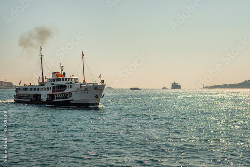 passenger ship crossing the bosphorus with a bus between europe and asia in Istanbul