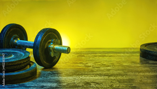 Heavy dumbbells in a gym concept. Vibrant, fitness background, with copy space for products or text