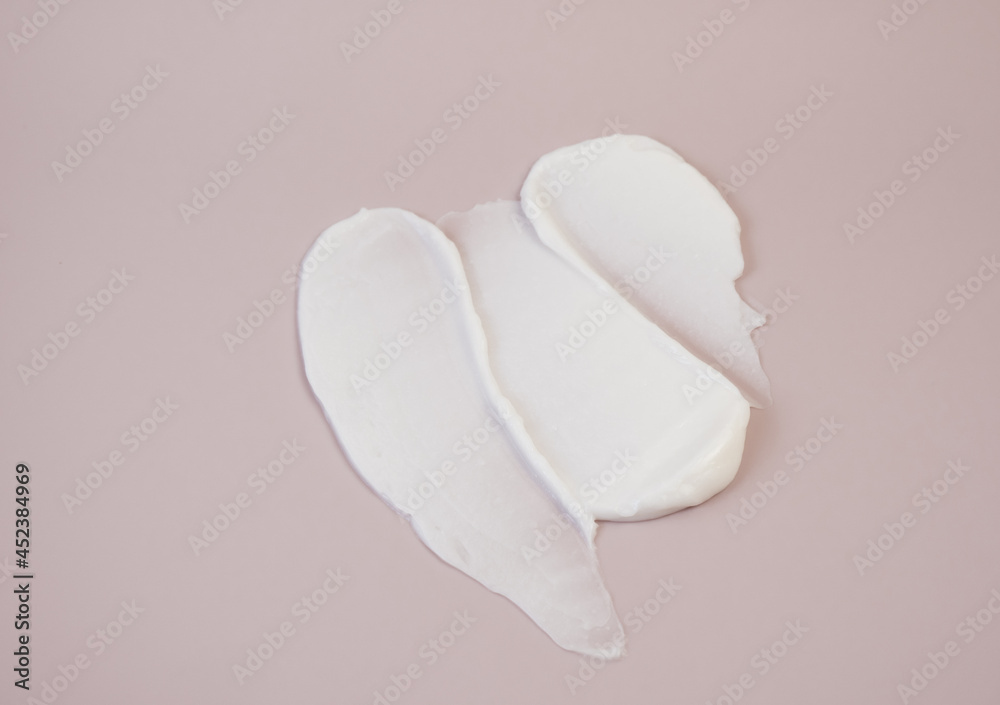 White cream texture on a pink background.