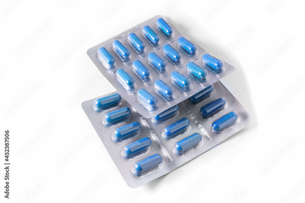 Packs of blue medical capsules on a white background Packs of blue medical capsules on a white background
