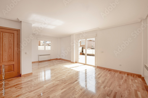 Empty living room of brand new detached house with parquet floors