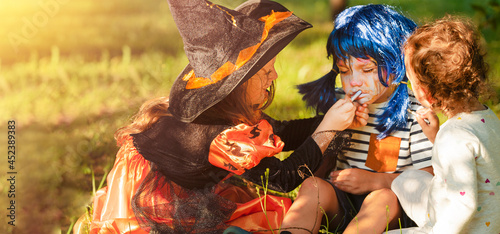 Boy and girls in carnival costumes celebrate Halloween
