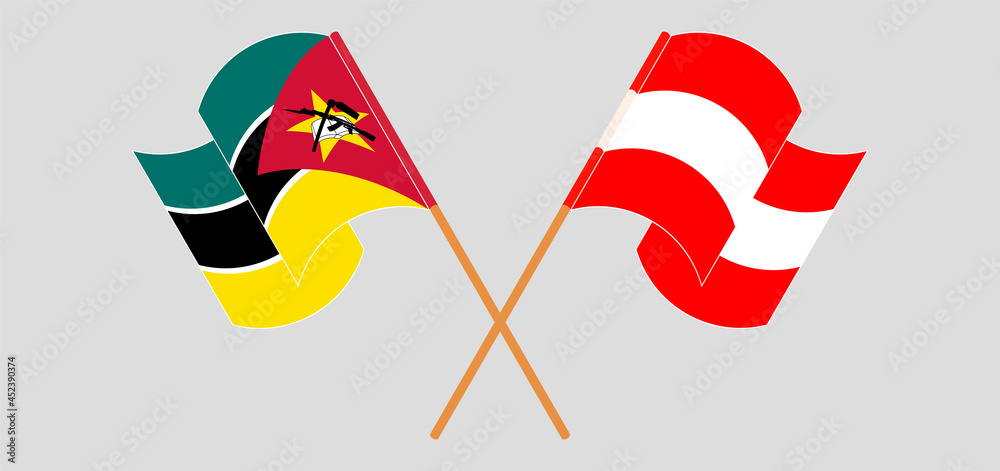 Crossed and waving flags of Mozambique and Austria