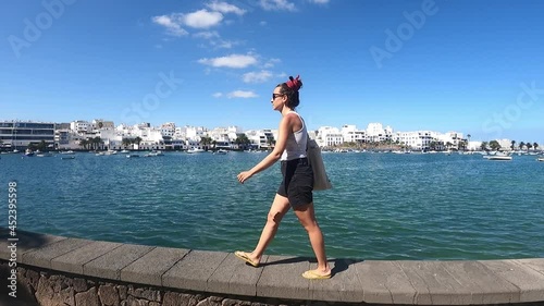 girl walking in the port of arrecife, Lanzarote, Canary islands, Spain photo