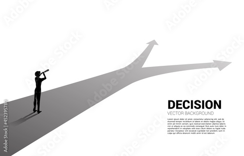 Silhouette of businessman looking through telescope on crossroad. business concept for mission and finding right decision.