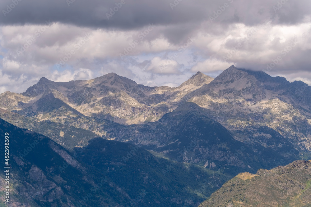 mountain peak of the Pyrenees mountain range in Spain, with clouds in the sky, horizontal