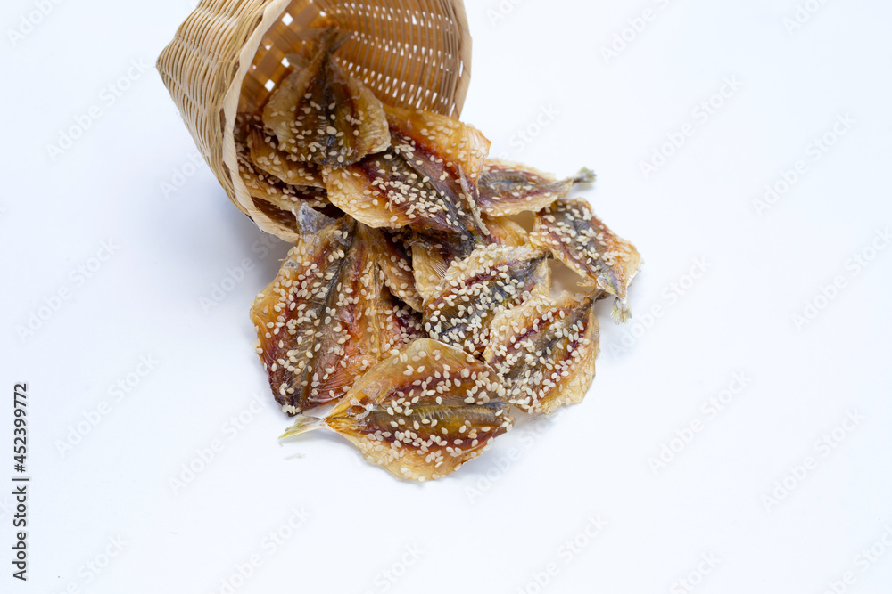 Dried fish with sesame seeds on white background. Dried fish with sesame seeds on white background.