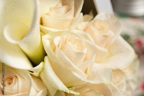 A view of several white roses and calla lilies box bouquet.